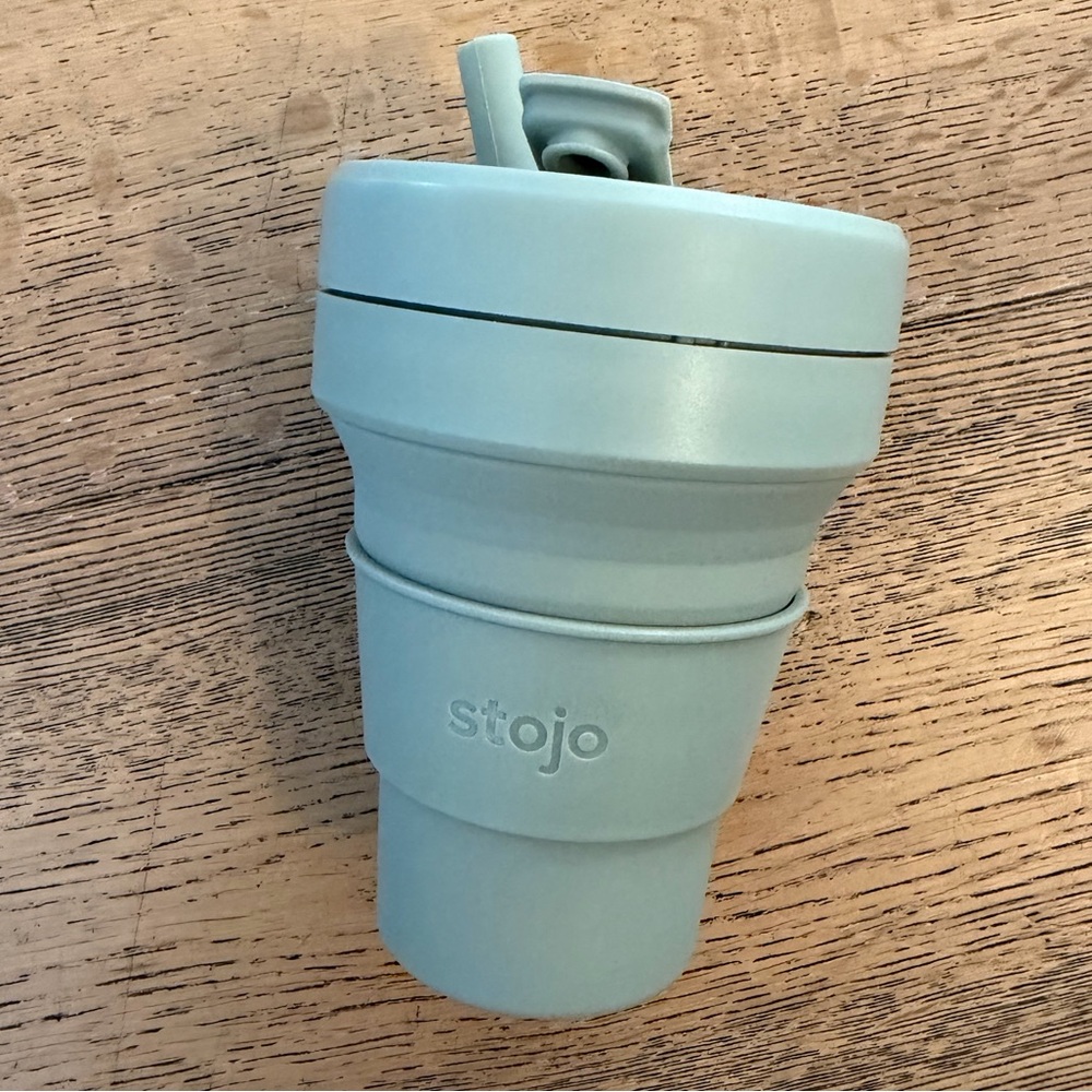 Stojo Collapsible Reusable Cup in a soft sage green